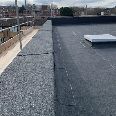 A flat roof with a bench on it.