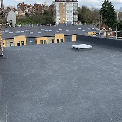 A flat roof with a satellite dish on top of it.
