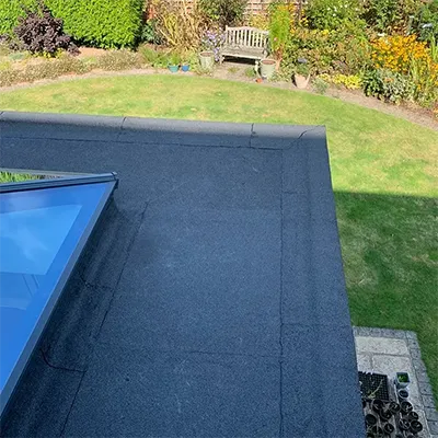 A blue roof with a bench in the background.