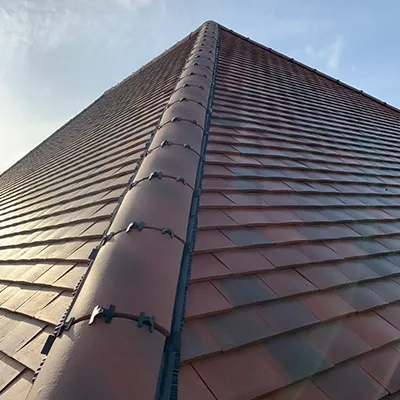 A close up of a roof with a sky background.