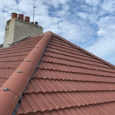 A red tiled roof with chimneys and chimneys.