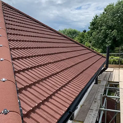 A roof that has a red tile on it.