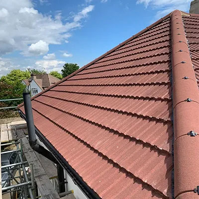 A red tiled roof with a black gutter.