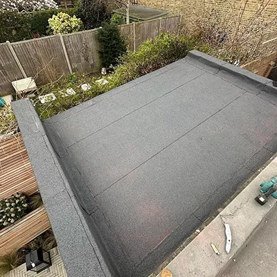 A view of a backyard with a flat roof.