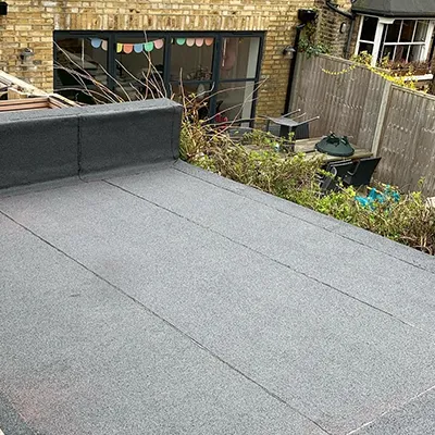 A man riding a skateboard down the side of a ramp.
