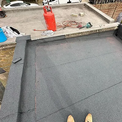 A person standing on top of a flat roof.